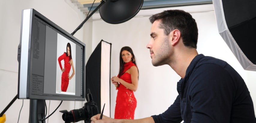 man watching woman in red dress at the laptop